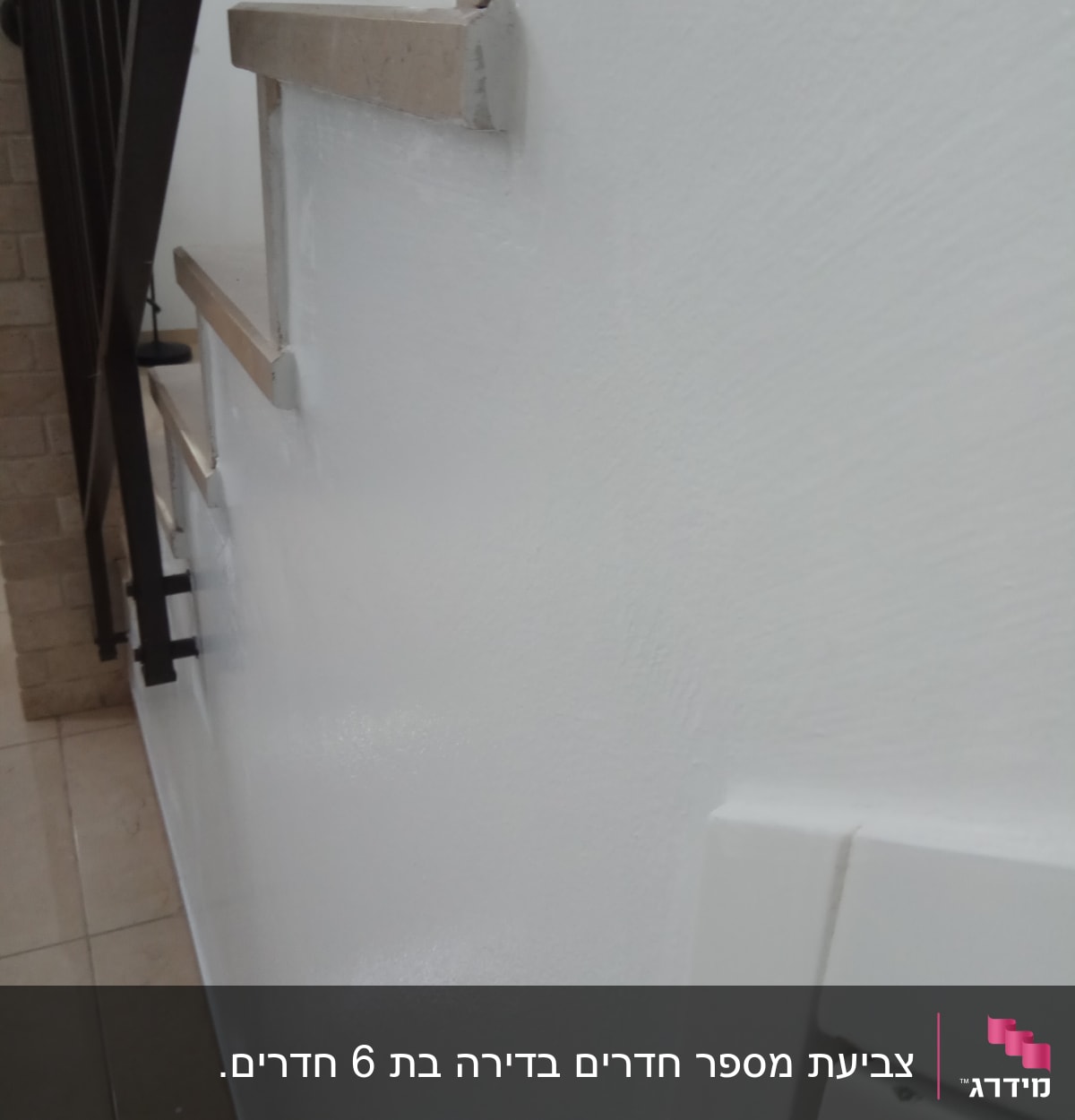 קיר צבוע בלבן עם מעקה מדרגות